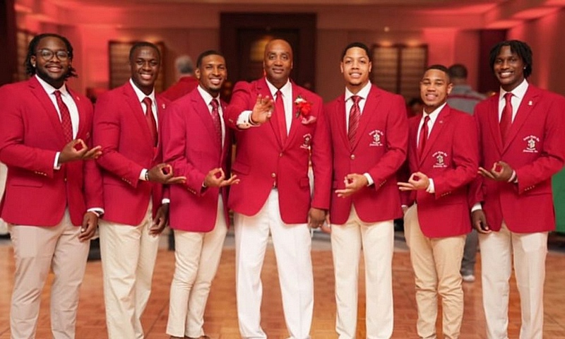 Members of Kappa Alpha Psi Fraternity, Inc. in crimson blazers at a ceremony